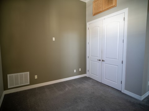 a room with two white doors and a carpeted floor