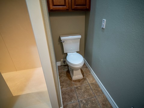 a bathroom with a toilet and a medicine cabinet