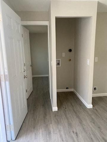a empty room with a white door and a hallway