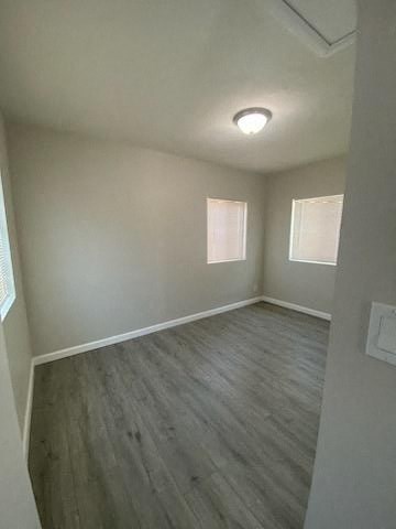 a empty room with wooden floors and white walls
