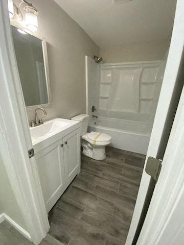 a bathroom with a toilet and a sink and a bath tub
