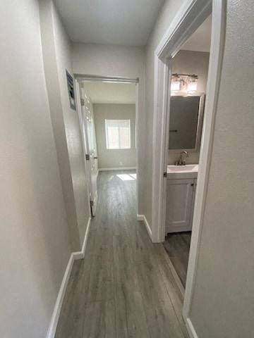 a hallway with a door to a bathroom