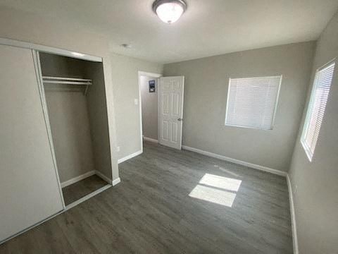 an empty room with a closet and a door