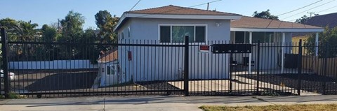 a house with a black fence and a gate