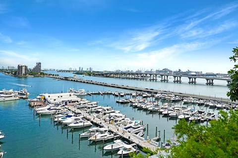a marina filled with boats next to a bridge