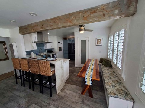 a kitchen and dining room with a long wooden table and chairs