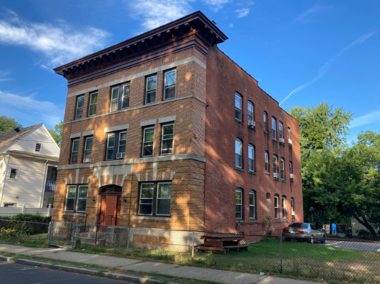 an old brick building on the side of a street