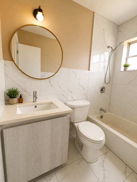 A bathroom with a sink, toilet and bathtub.