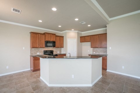 A kitchen with a white island in the middle.