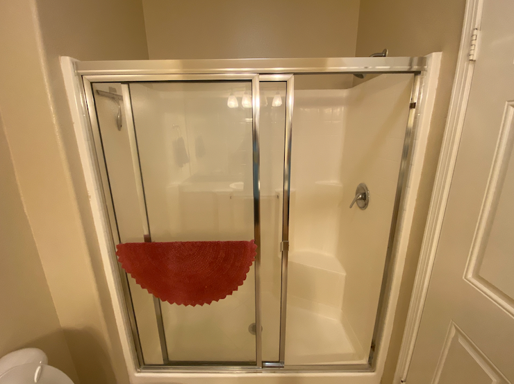 a small bathroom with a shower with a glass door