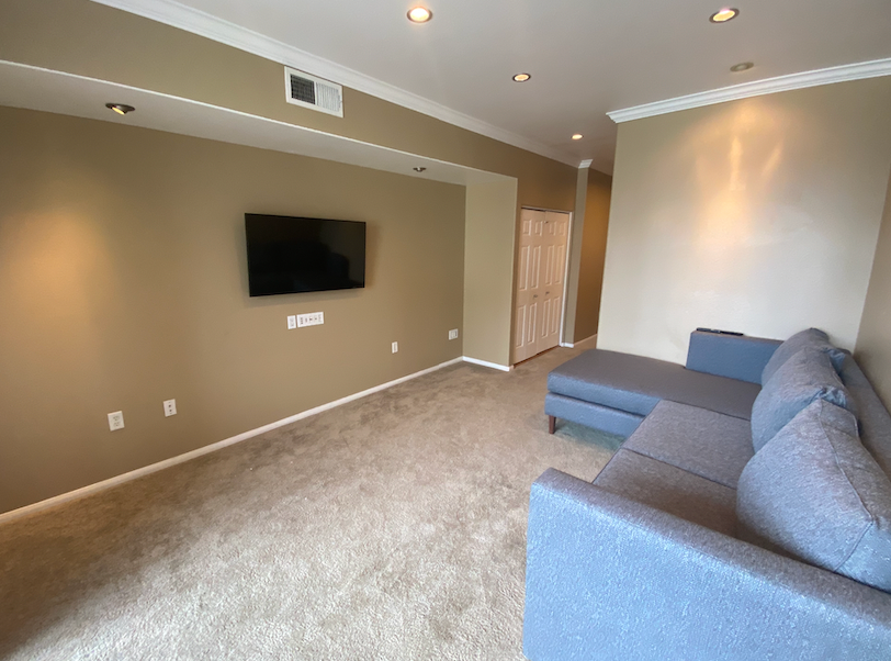 a living room with a couch and a tv