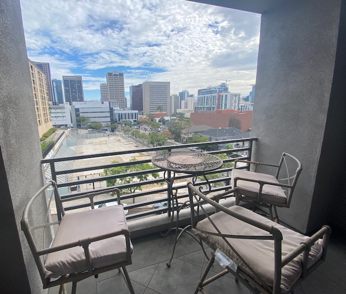 a balcony with a city view and chairs and a table