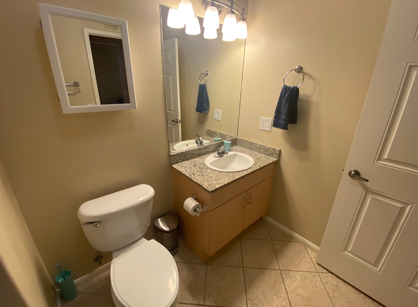 a bathroom with a toilet and a sink and a mirror