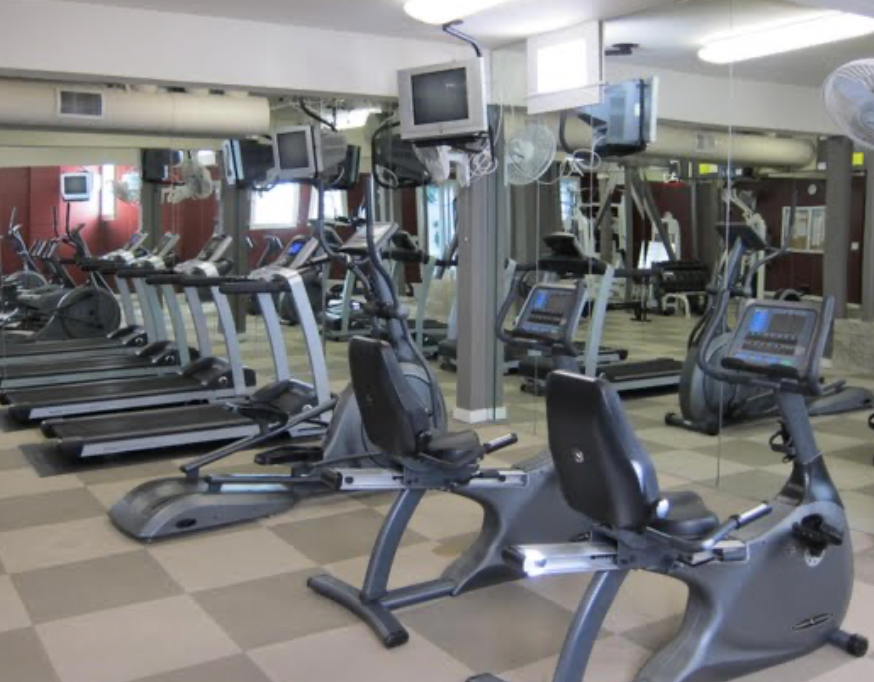 the gym has a lot of exercise equipment in it