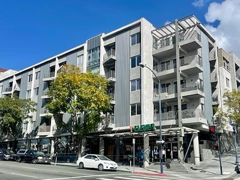 a white car parked in front of an apartment building