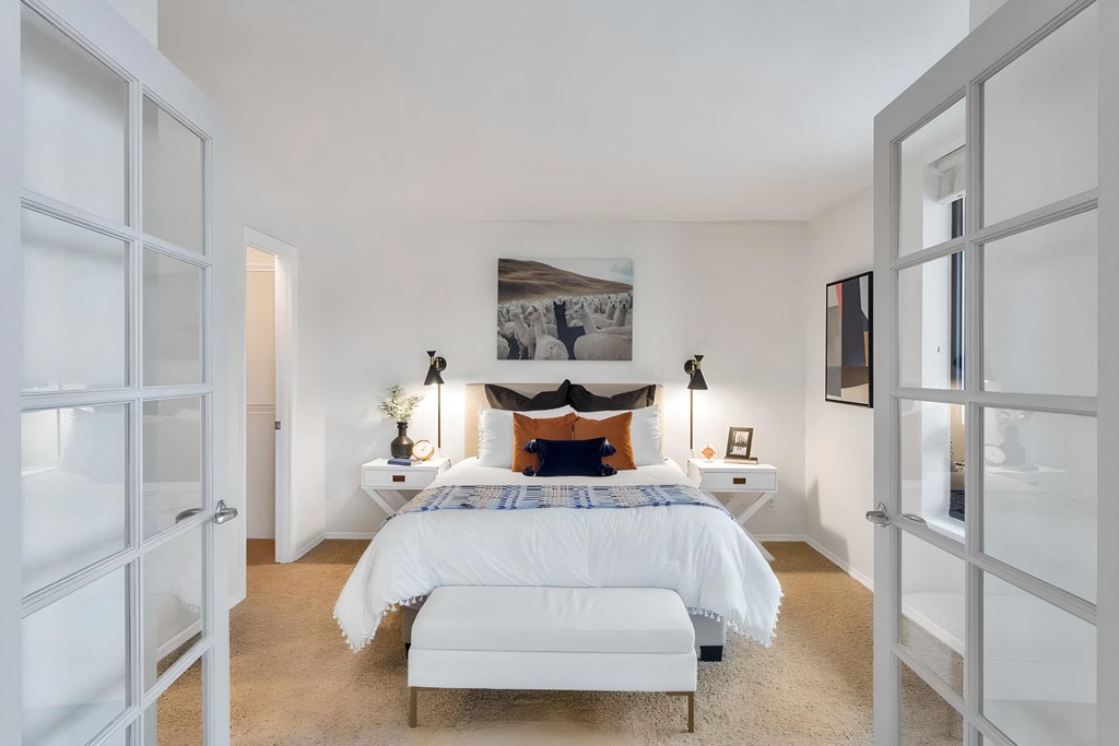 a bedroom with a bed and a white closet