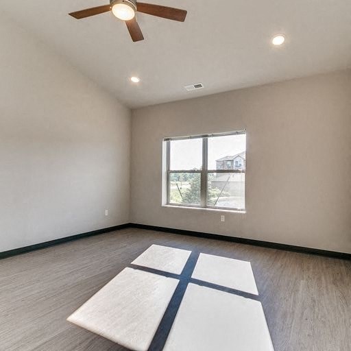 an empty room with a window and a yoga rug