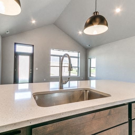 an empty kitchen with a sink and a faucet