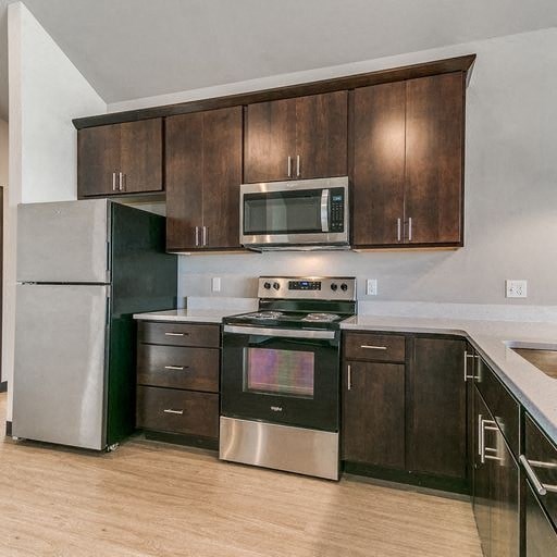 a kitchen with stainless steel appliances and wooden cabinets