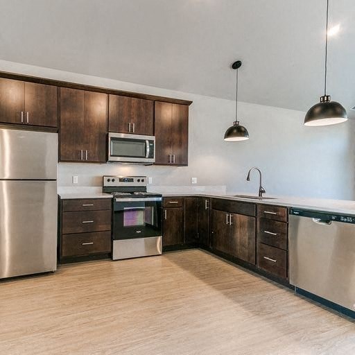 a kitchen with stainless steel appliances and wooden cabinets