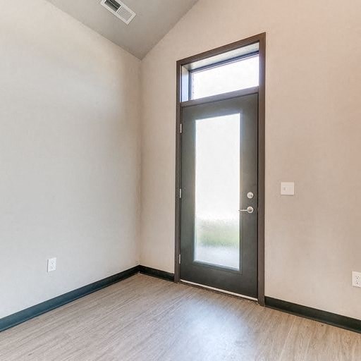 a empty room with a door and a window