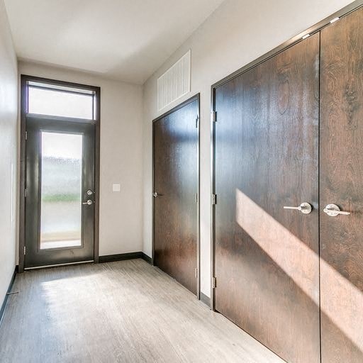 a hallway with two doors and a window