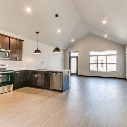 an empty kitchen with a microwave and a sink