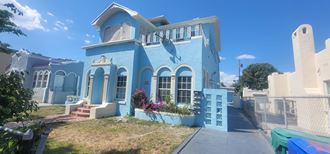 a blue house with a dolphin painted on the side of it