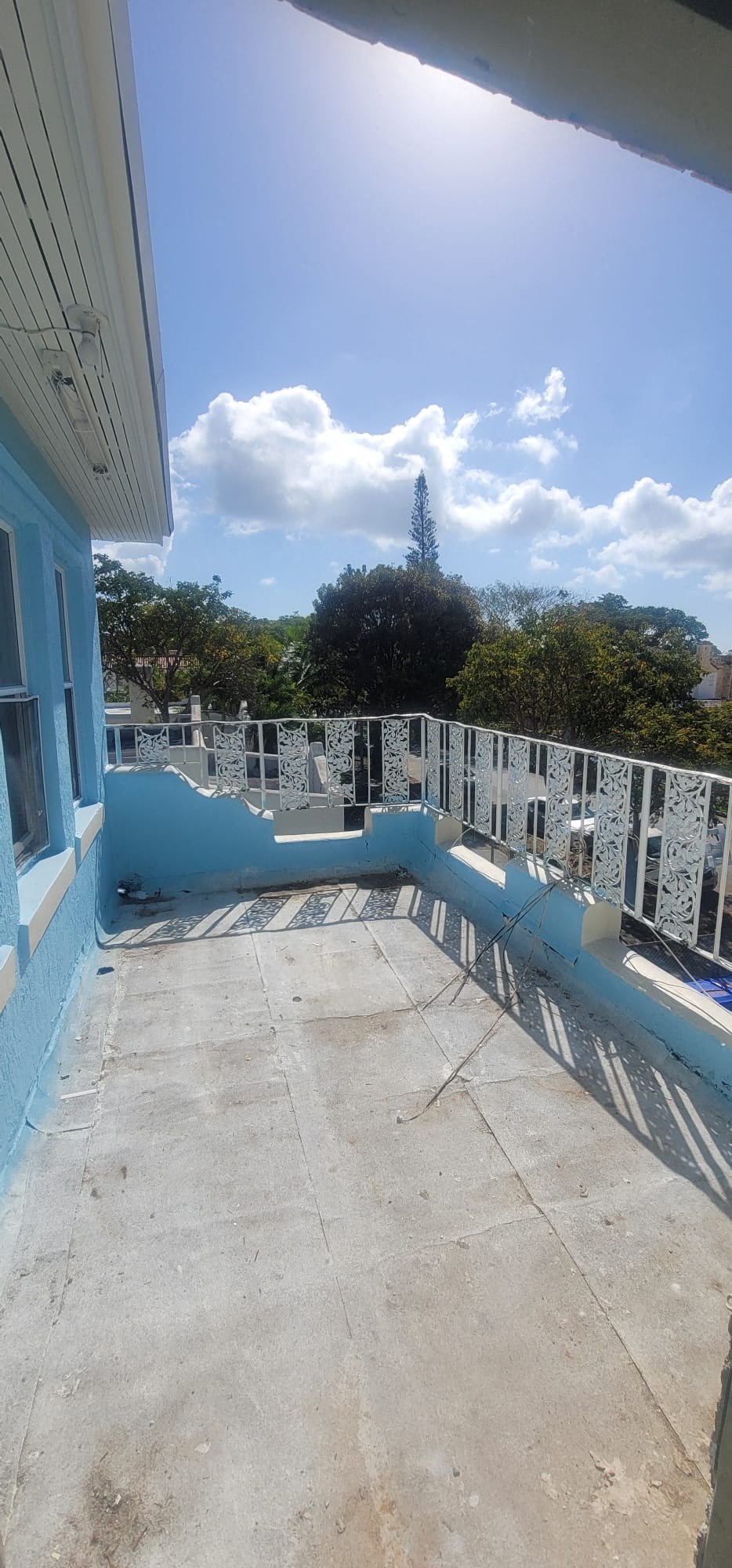 a view of the roof of a house with a balcony