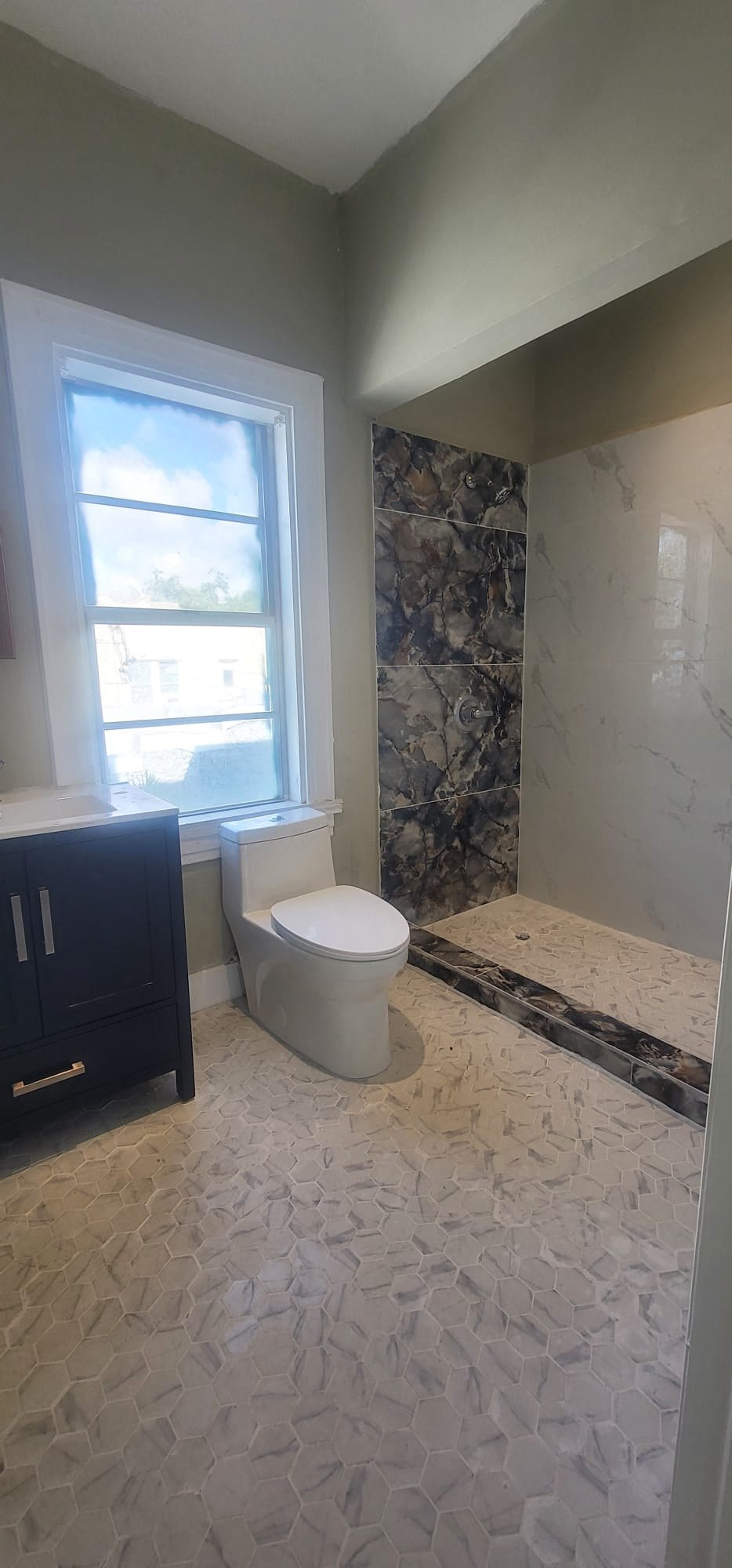 a bathroom with a toilet and a window