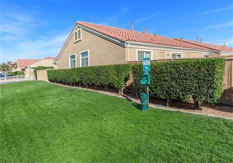 a house with a green sign in the grass