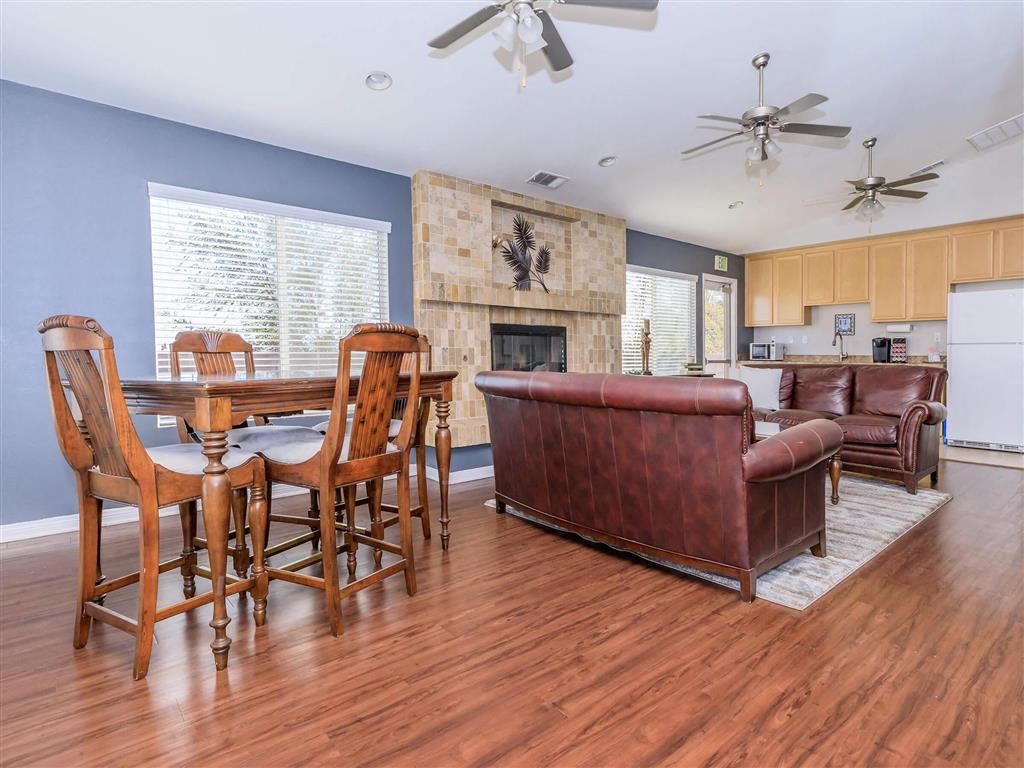 a living room with a table and a leather couch