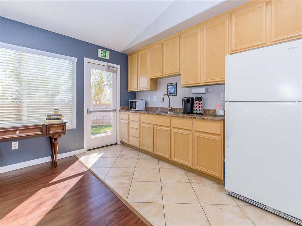 a kitchen with wooden cabinets and a white refrigerator