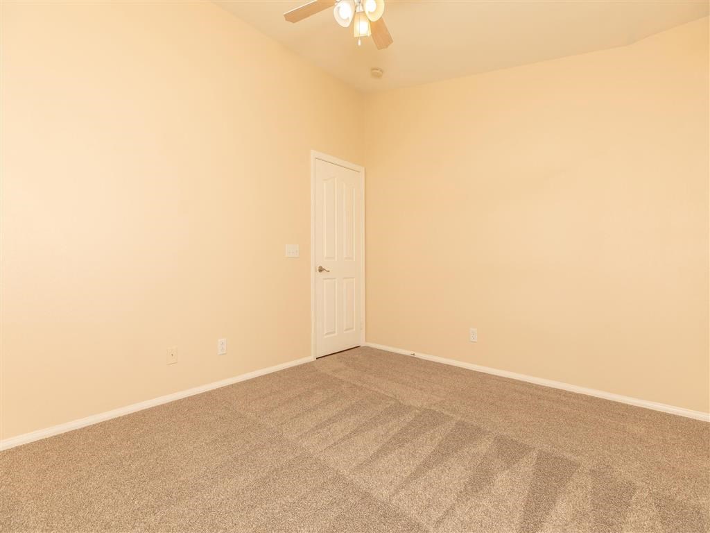 a room with carpet and a white door
