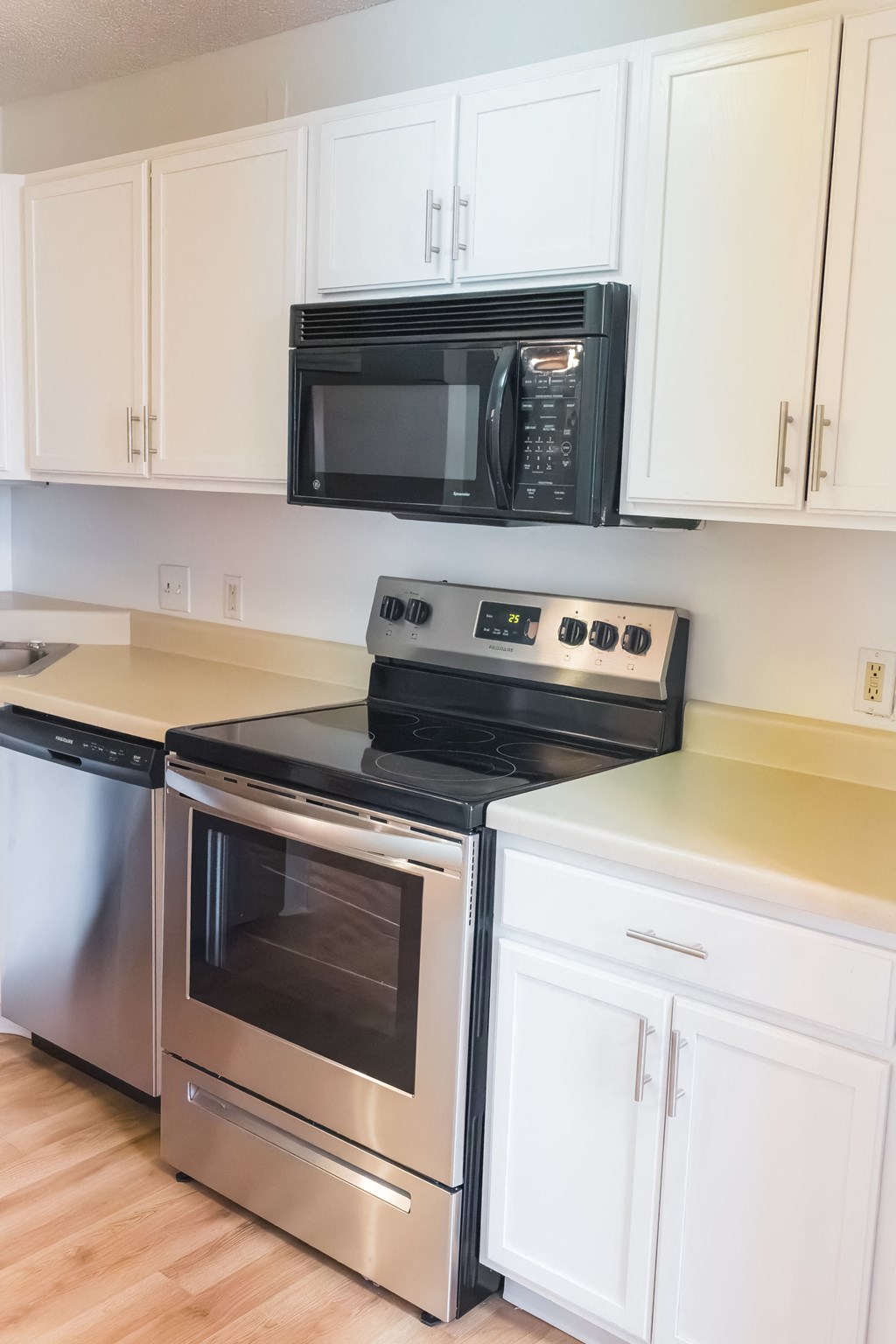 a kitchen with stainless steel appliances and white cabinets