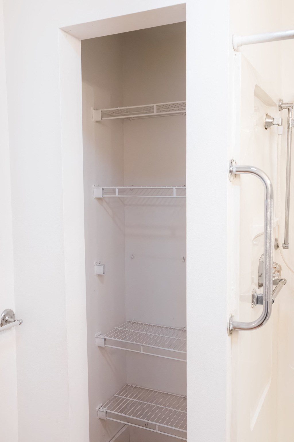 a small bathroom with a shower and a closet