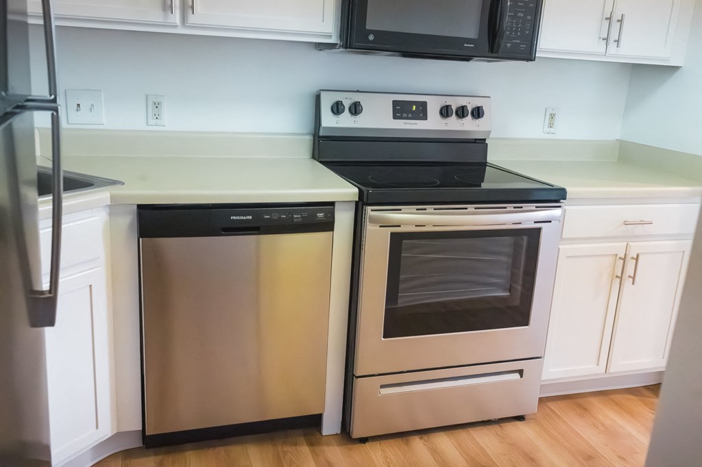 a kitchen with stainless steel appliances and white cabinets