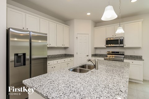 a kitchen with granite counter tops and stainless steel appliances