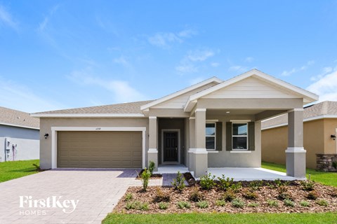 A modern house with a garage door and a front yard.