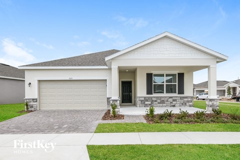 a white house with a driveway and a garage door