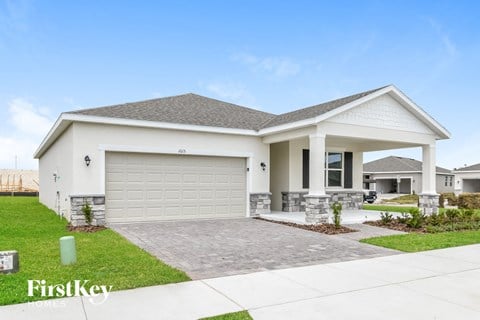 a white house with a driveway and a garage door