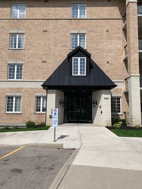 an entrance to a building with a black roof