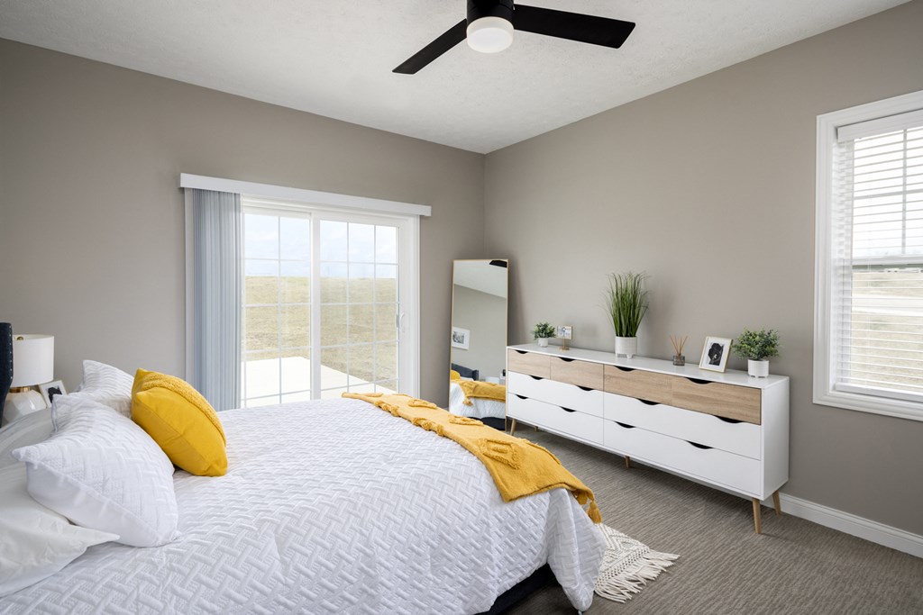a bedroom with a white bed and a white dresser