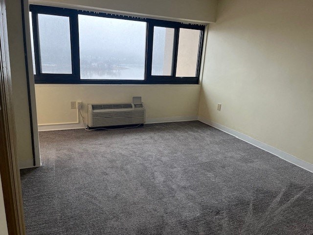 an empty room with a heater and a window