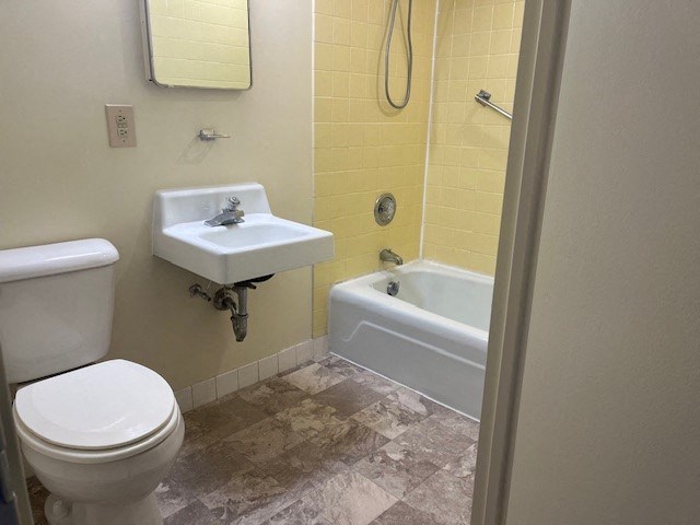 a bathroom with a sink toilet and a bath tub