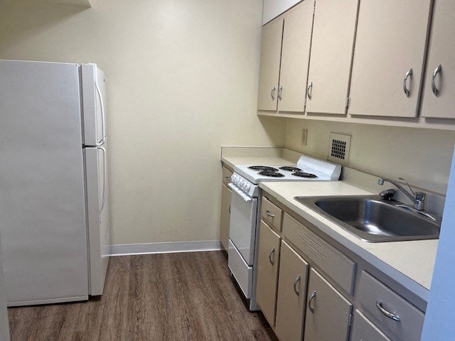 a kitchen with a sink and a refrigerator
