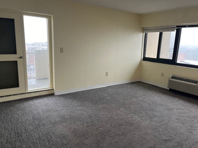 an empty room with a window and a radiator