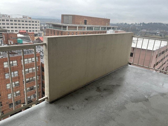 a balcony with a view of a city