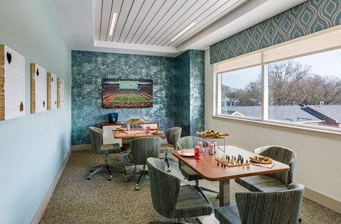 a dining room with tables and chairs and a window