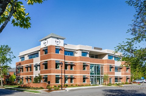a large brick building with a clock on the side of it